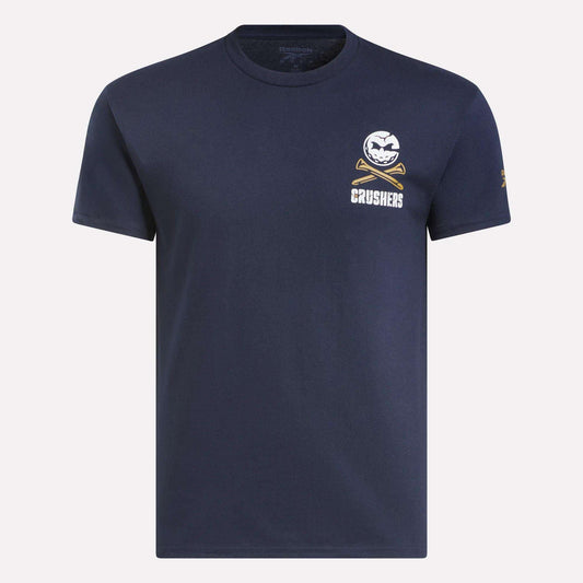 The Men's Crushers Stacked Logo Tee by Reebok is a navy short-sleeve shirt featuring a small white baseball and crossed bats graphic above “CRUSHERS” on the left chest, inspired by Bryson DeChambeau’s team spirit.