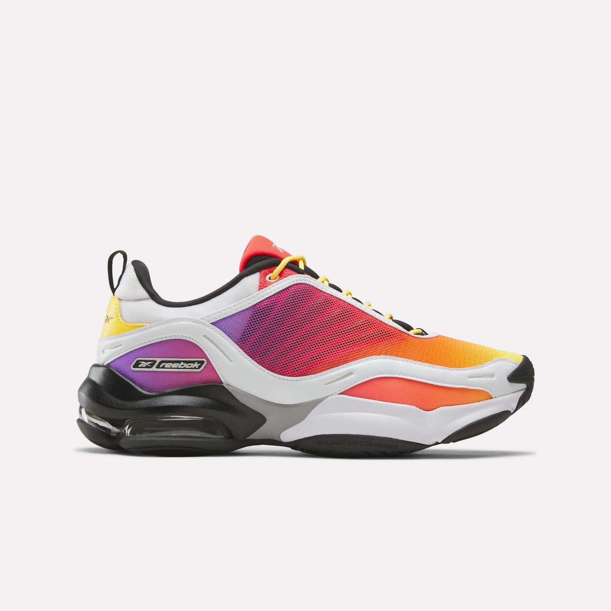 The Reebok x Brain Child DMX Series 3000 Shoes features a gradient mesh upper (yellow, orange, pink, purple), black accents, white sole, and responsive cushioning—displayed in side profile on a plain white background.