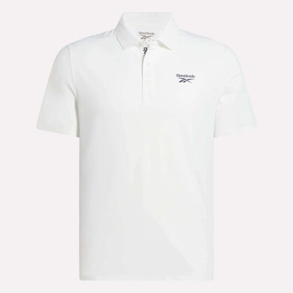 The Reebok Men's Bonded Pique Polo Shirt is plain white with short sleeves, a collar, and three buttons. A black Reebok logo appears on the left chest. The background is light gray.
