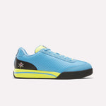 Side view of the Reebok x Icecream Board Flip Shoes in blue with black and yellow accents, perforated upper, black sole, skull and crossbones heel detail, low-top silhouette, and padded tongue inspired by early-2000s style.
