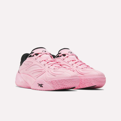 A pair of Reebok Angel Reese 1 Shoes for big kids in light pink with black accents and textured pink soles, positioned side by side on a white background.