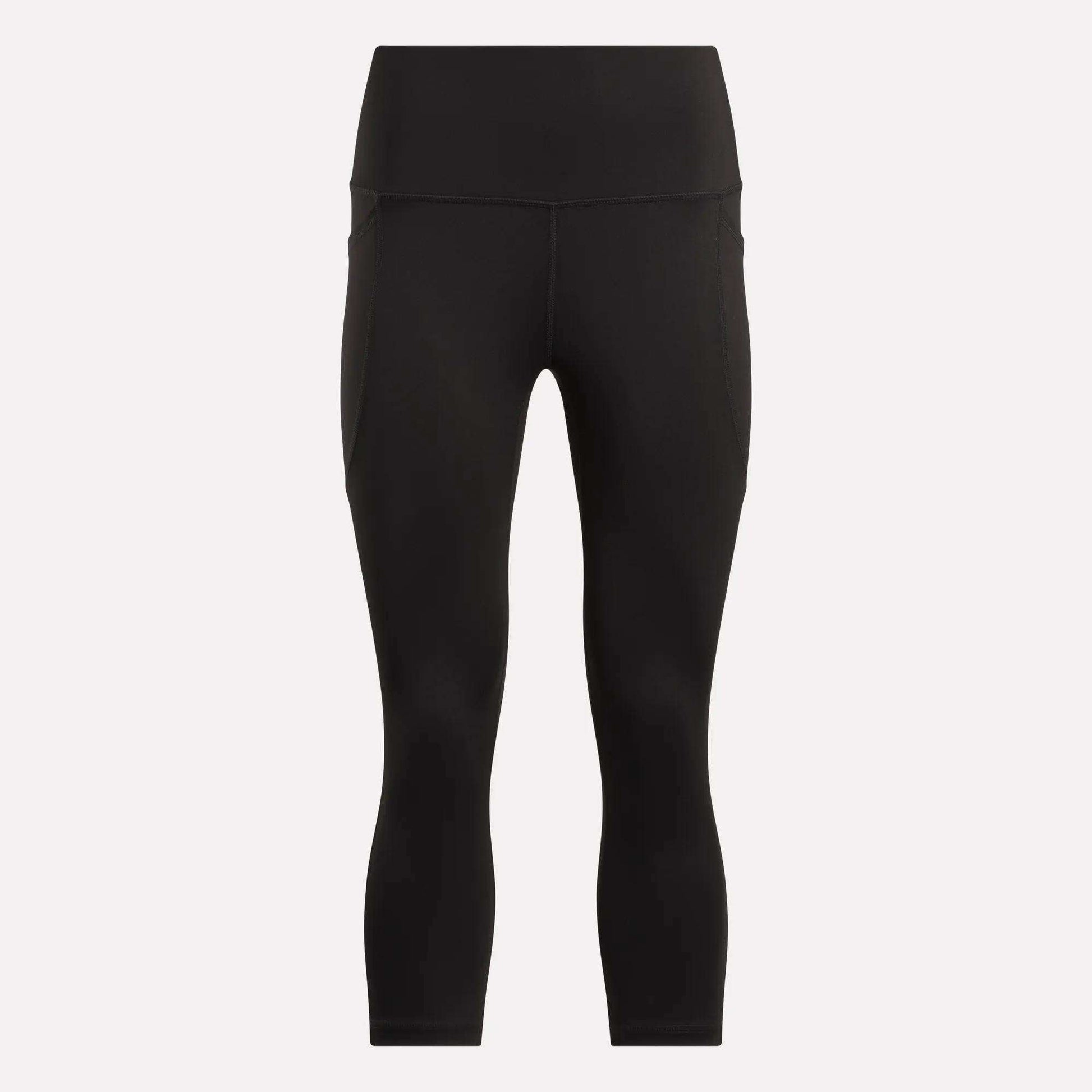 Women's Capri Leggings by Reebok in black, featuring a high waist, ankle length, side pockets, and an adjustable waistband. Shown on a plain white background.