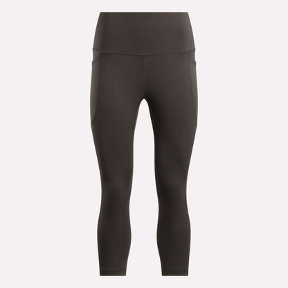 Reebok Women's Capri Leggings in black, shown on a plain light background. These fitted, high-waisted leggings offer a smooth finish, subtle seam details, and ankle-length style—ideal for any fitness routine.