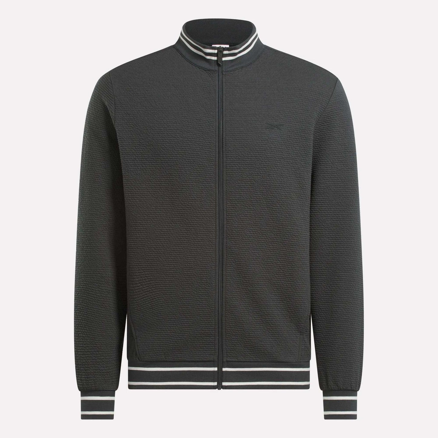 The Men's Club Sport Textured Jacket by Reebok is a black thermal knit jacket with a sporty, minimalist design and features white and black striped ribbed collar, cuffs, and waistband. No visible logos or patterns for a clean look.