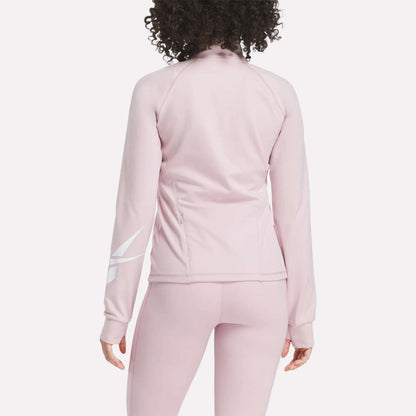 A woman with curly hair is seen from the back wearing the Reebok Women's Motion Core Full-Zip Hoodie in light pink with a white diagonal design on the right sleeve—perfect for workouts. Matching leggings complete her athletic look.
