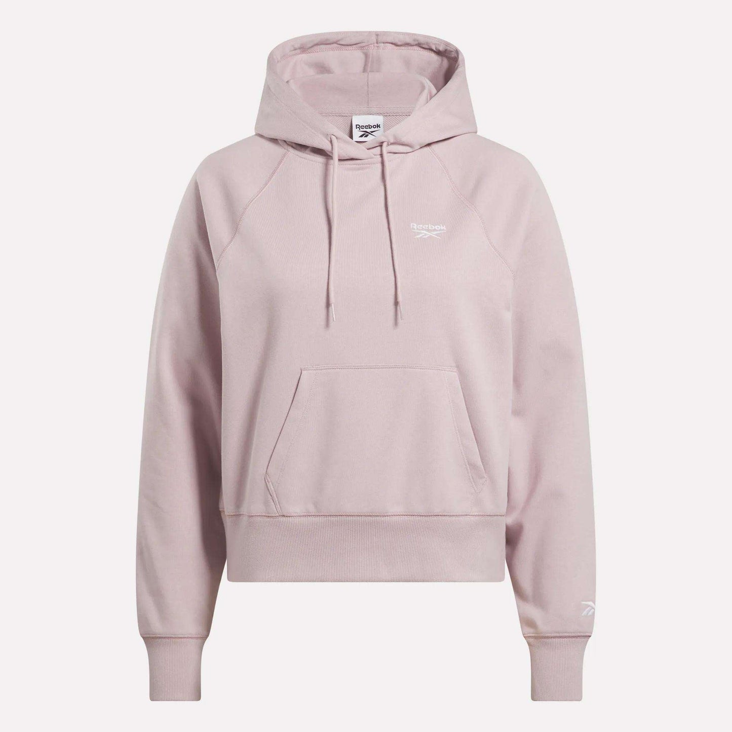 The Women's Small Vector Cropped Hoodie by Reebok comes in light pink French terry, featuring a front pocket, drawstrings, and white logos on the chest and sleeve. Shown against a plain white background.