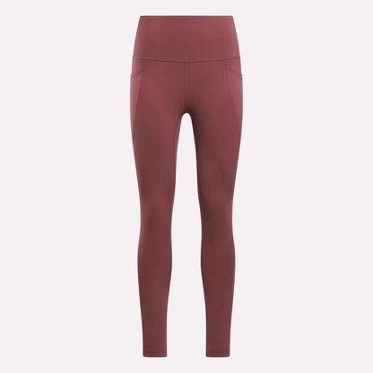 Reebok Women's High-Rise Tights in a muted reddish-brown feature side pockets, visible seam details, and a high-rise waistband. These full-length training tights are displayed on a plain light background.