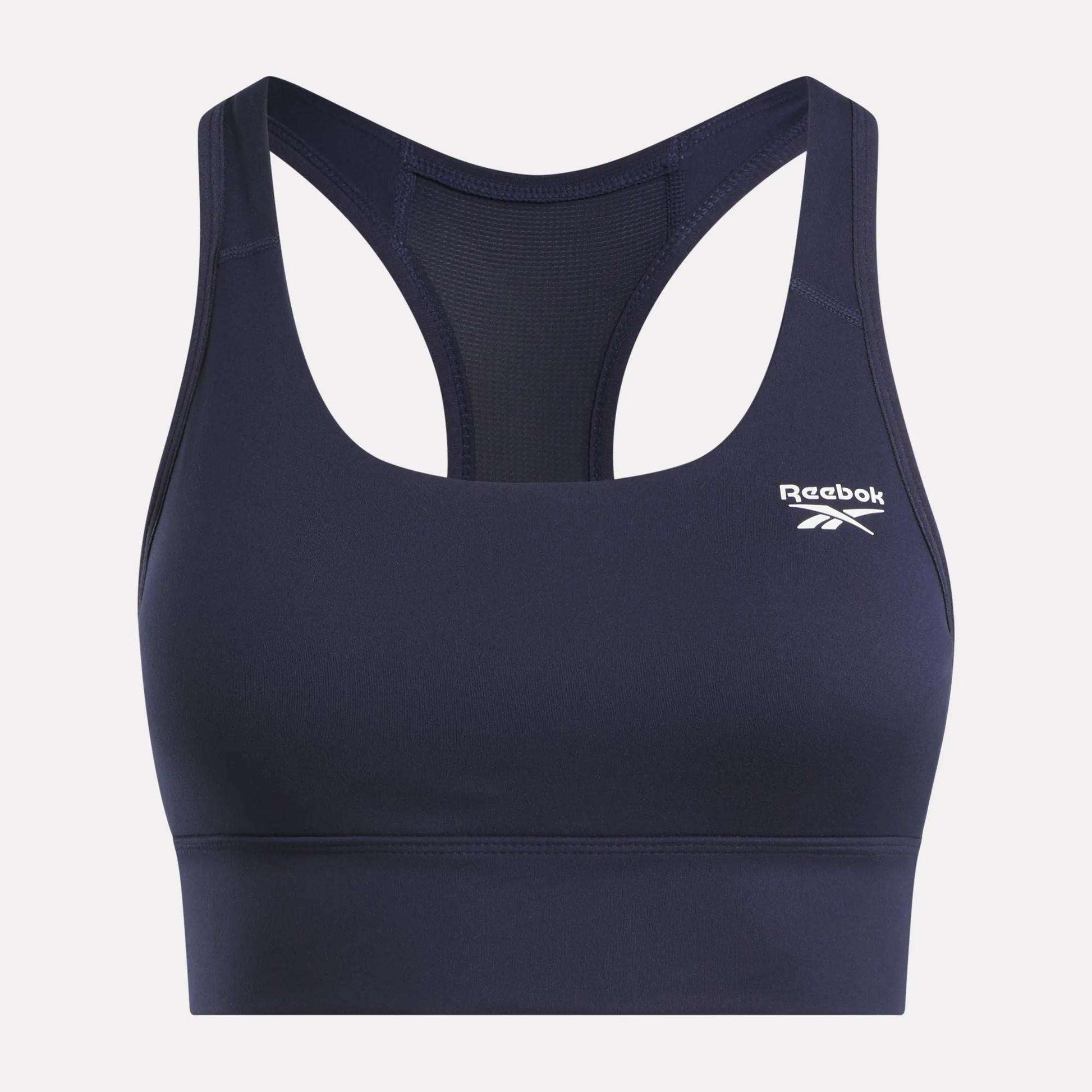 The Reebok Women's Rush Medium-Impact Sports Bra features a navy blue racerback design, mesh back panel, and a white logo on the left chest—perfect for medium-impact workouts.