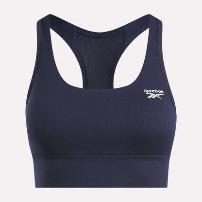 The Reebok Women's Rush Medium-Impact Sports Bra features a navy blue racerback design, mesh back panel, and a white logo on the left chest—perfect for medium-impact workouts.
