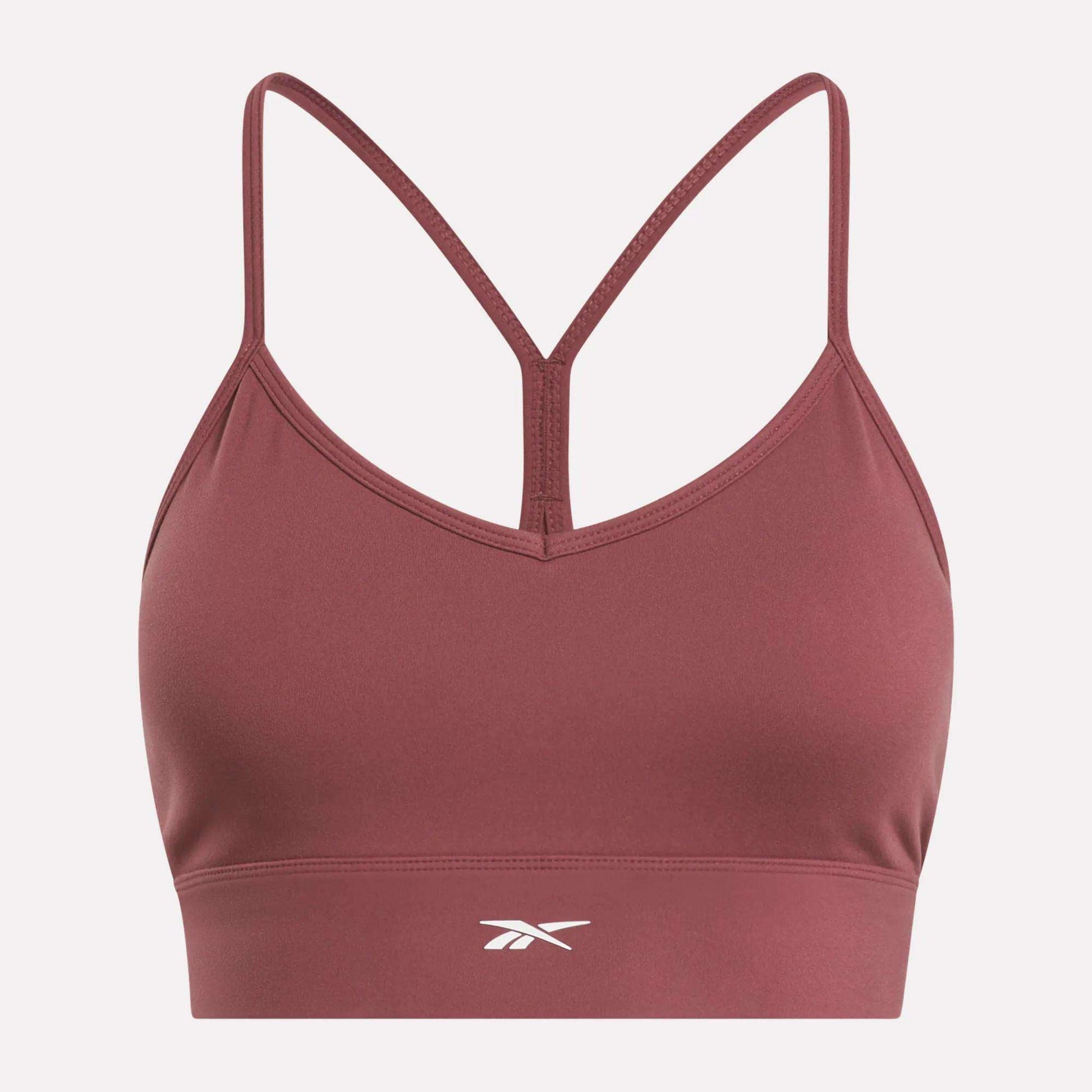 The Reebok Women's Back Bra is a maroon medium-impact sports bra with thin racerback straps and a white front center logo, shown on a plain white background.