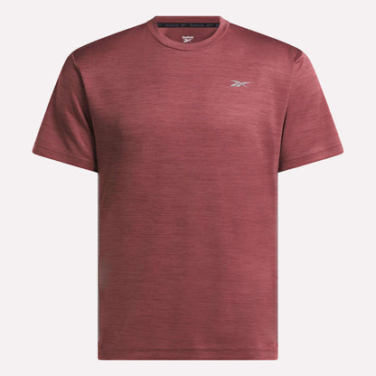 The Reebok Men's Director Short Sleeve Top is a plain maroon training t-shirt with short sleeves and a small white logo on the left chest, shown on a white background. Its stretchy fabric makes it ideal for any workout.