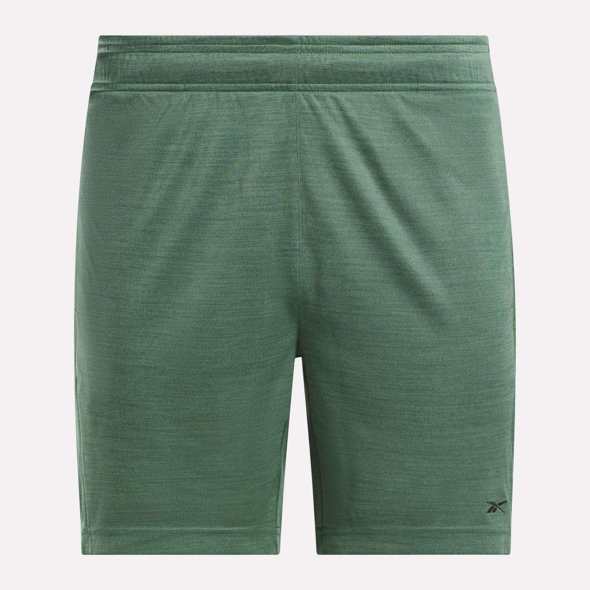 Reebok Men's Inclination Shorts in green with a subtle texture, elastic waistband, and small black logo by the left hem. These performance shorts are shown on a plain white background.