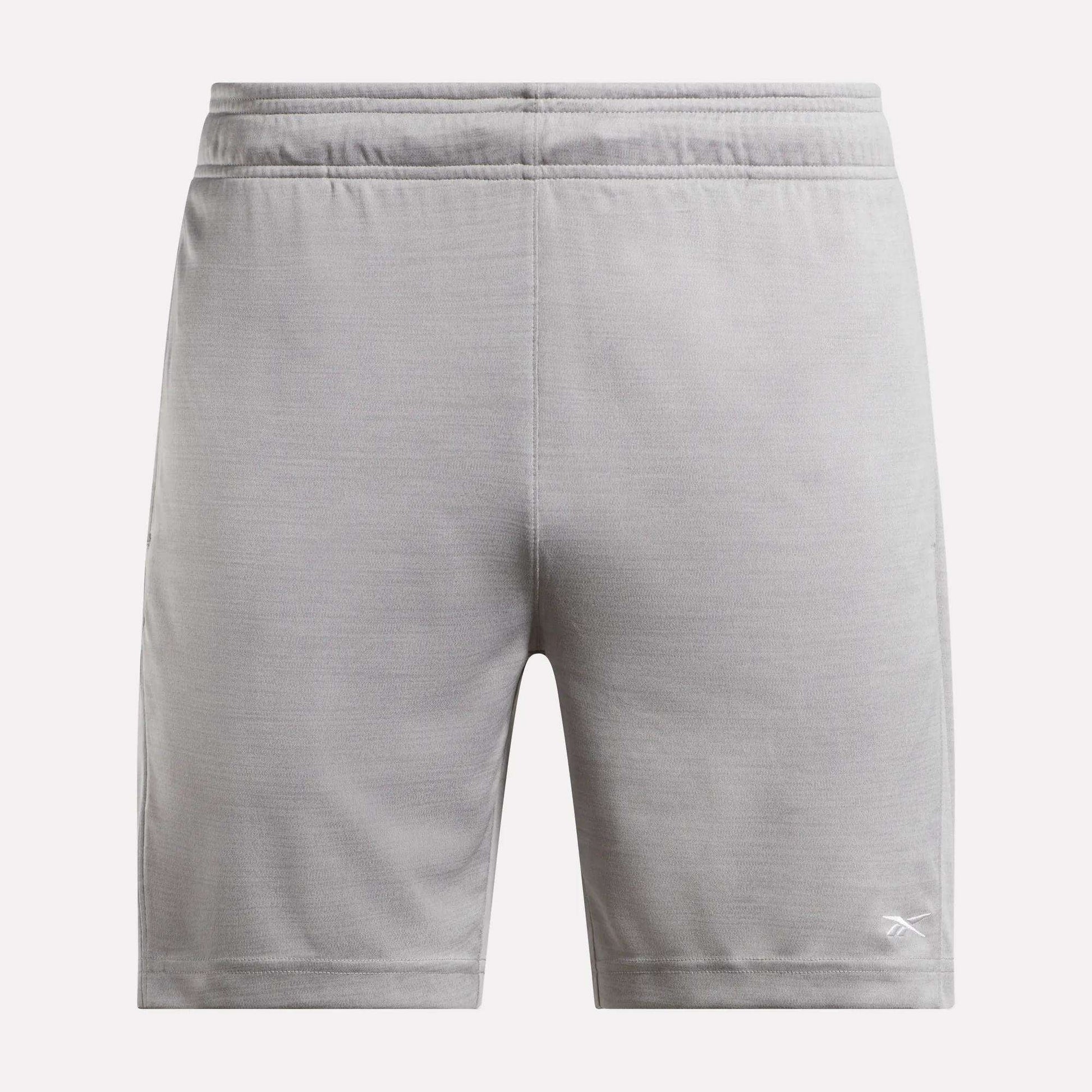The Reebok Men's Inclination Shorts feature an elastic waistband and a white logo on the lower left leg, shown from the back in light gray—a versatile choice for men's workouts.