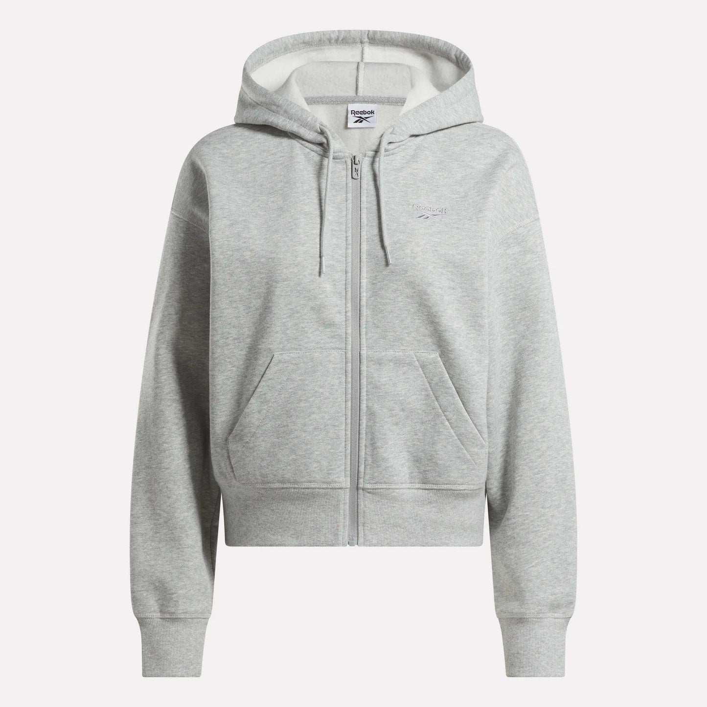 The Reebok Women's Cropped Full-Zip Hoodie in light gray features a zip-up front, hood with drawstrings, front pockets, and ribbed cuffs and hem, shown against a plain white background.