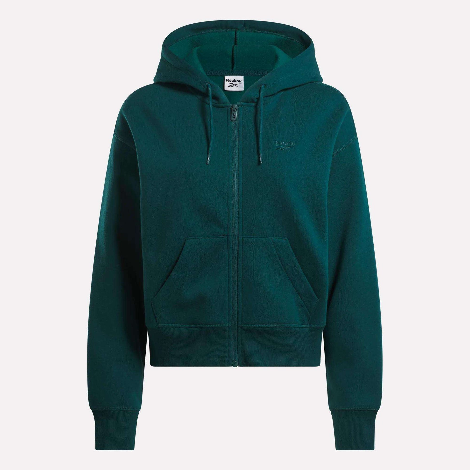 The Reebok Women's Cropped Full-Zip Hoodie in dark green features a cozy knit fabric, hood, front zipper, roomy pockets, and a small embroidered logo on the left chest, shown against a plain white background.