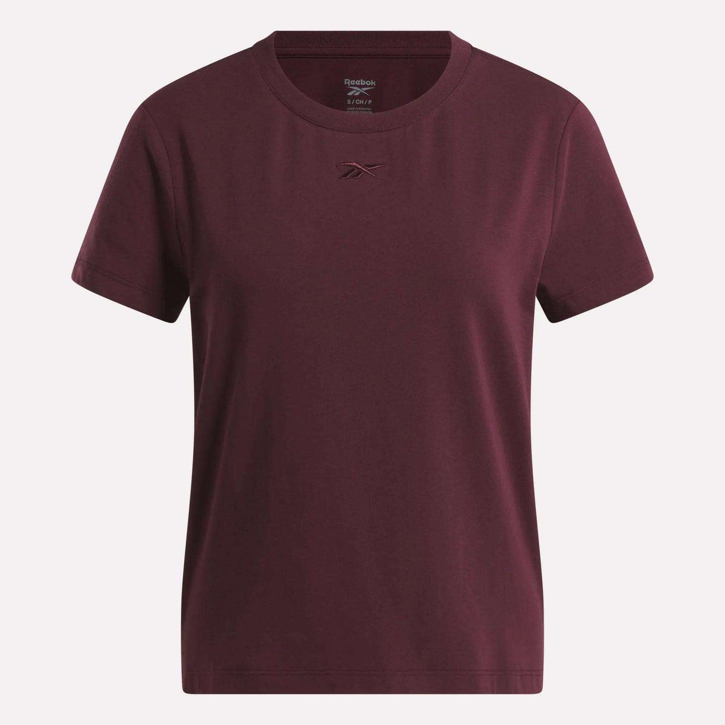 The Women's Graphic Glow Top by Reebok is shown on a white background, featuring a classic maroon design with a small embroidered logo on the chest.