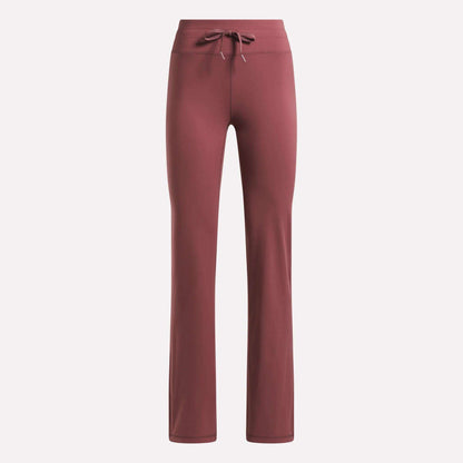 Reebok Women's Highstreet High-Rise Pants in dusty rose feature a straight-leg cut, stretchy fabric, and a drawstring waistband, shown against a plain light background.