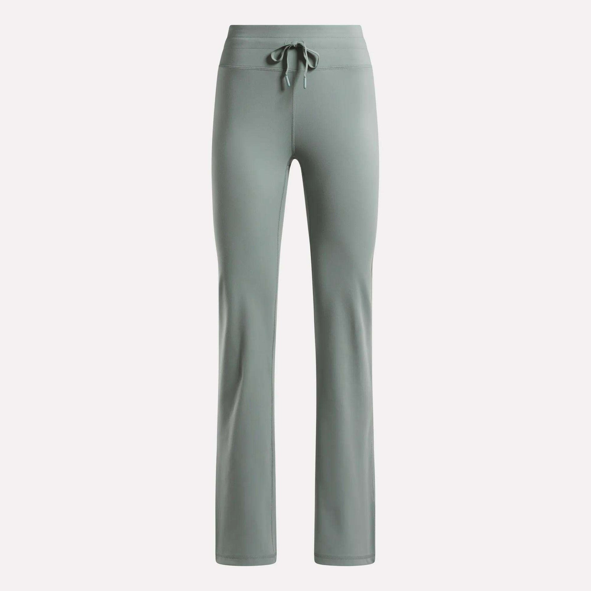 The Reebok Women's Highstreet High-Rise Pants in light sage green feature a drawstring waistband, straight legs, and stretchy fabric for comfort—ideal lounge wear, shown on a plain white background.