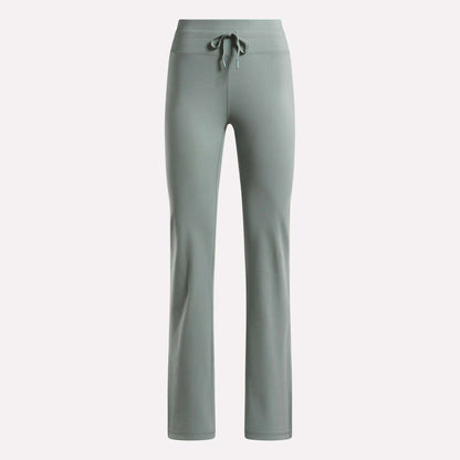 The Reebok Women's Highstreet High-Rise Pants in light sage green feature a drawstring waistband, straight legs, and stretchy fabric for comfort—ideal lounge wear, shown on a plain white background.