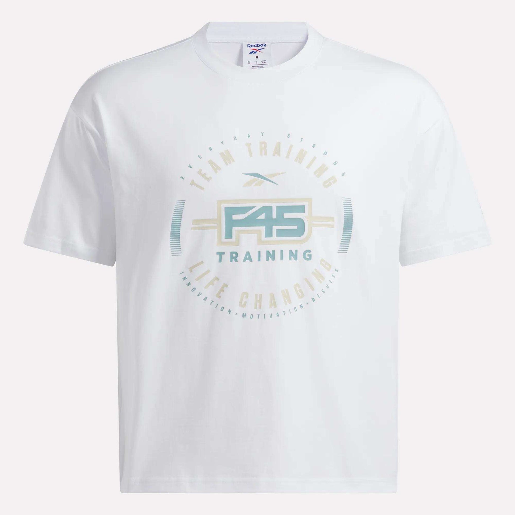 The Reebok X F45 Training Graphic T-Shirt by Reebok features the official F45 logo and circular "Team Training, Life Changing" text in soft pastel blue, tan, and beige. Designed as a men’s workout shirt with a relaxed fit, this t-shirt offers both comfort and style with no visible background for a clean look.