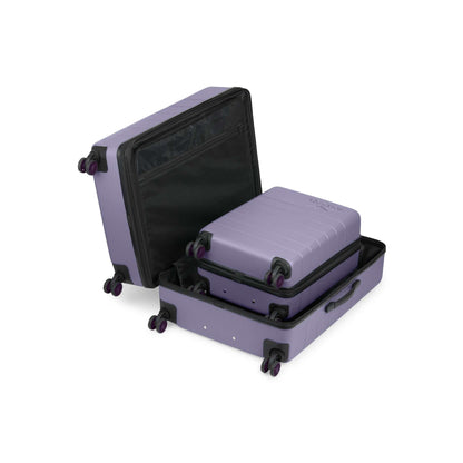 The Reebok Captain 2 Piece Luggage Set, shown open on a plain white background, includes a large and small purple hard-shell suitcase with spinner wheels and a nesting design for easy storage.