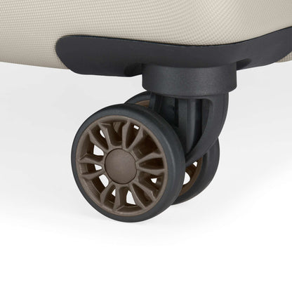 Close-up of a brown spinner wheel on the corner of a beige suitcase from the Reebok Captain 2 Piece Luggage Set, displaying sturdy spokes and durable design—ideal for travelers seeking reliable luggage.