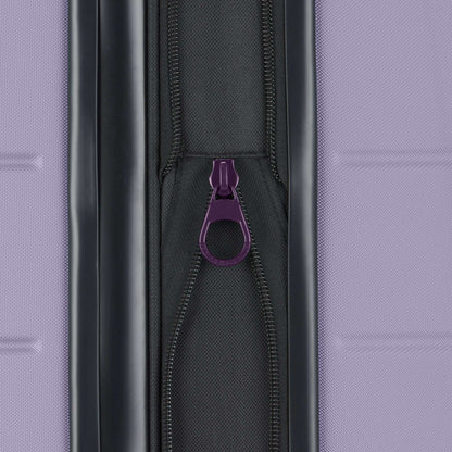 Close-up of a purple zipper pull on a black zipper, set against textured purple—part of the Reebok Captain 2 Piece Luggage Set, known for durability and smooth spinner wheels, ideal for travel.
