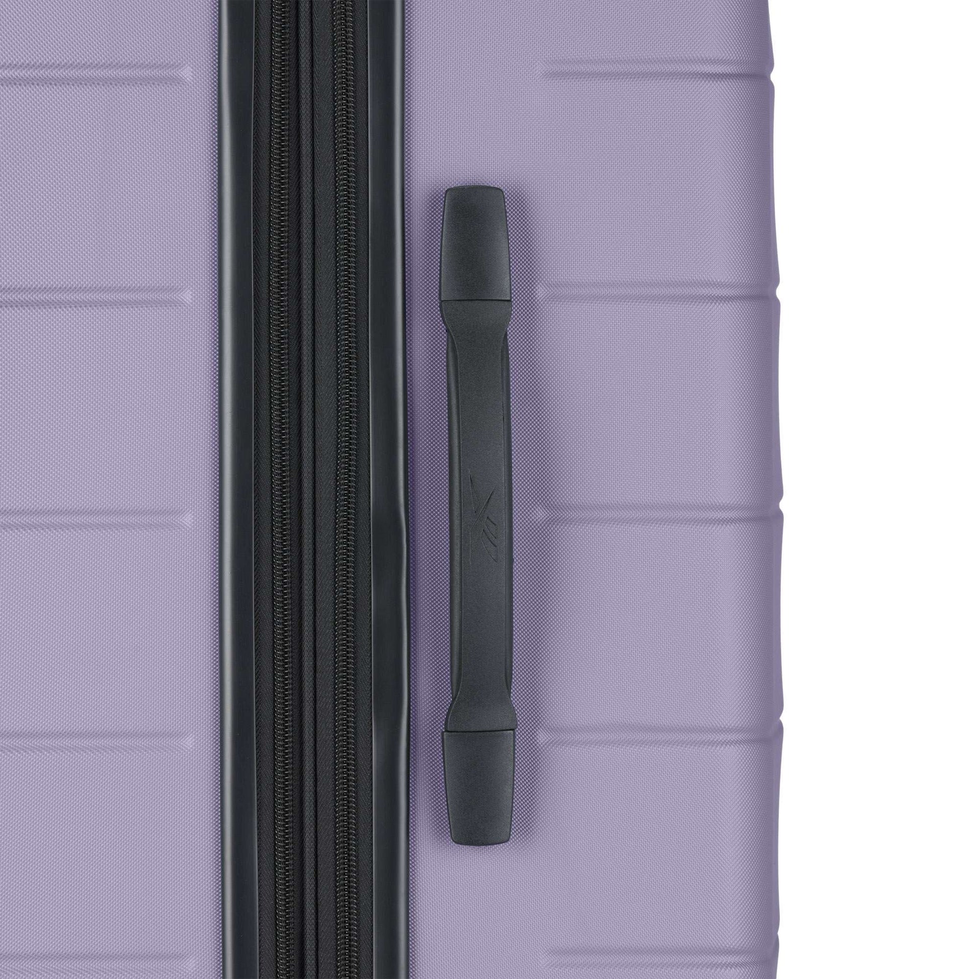 A close-up of the Reebok Captain 2 Piece Luggage Set shows its purple hard shell, black zipper and side handle, and smooth spinner wheels—blending durability with style.