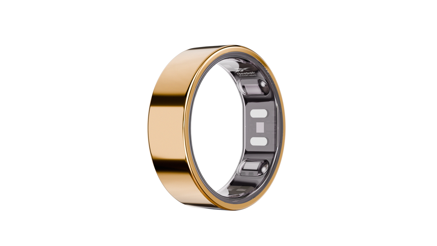 The Reebok Smart Ring by Reebok, shown in gold with a smooth, polished finish and built-in biometric sensors, is displayed against a simple white background.