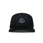 The Reebok Madison II Golf Hat is a black cap made from recycled polyester with a white embroidered polygon logo and GOLF on the front, featuring an adjustable snapback, shown against a plain white background.