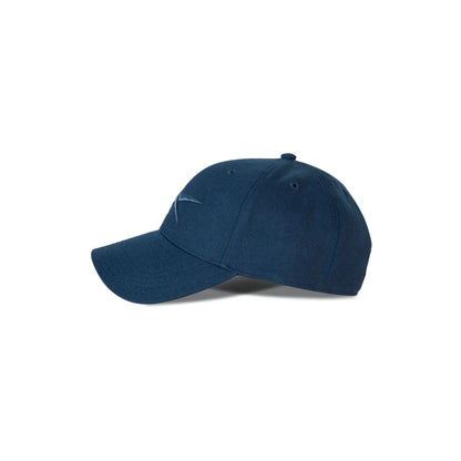 A Reebok Vector Baseball Cap in navy blue with a curved brim and embroidered front logo, featuring an adjustable snapback closure, is shown against a white background.
