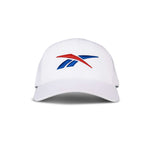 The Reebok Vector Baseball Cap, shown from the front against a white background, features a red and blue stylized logo on its white design.