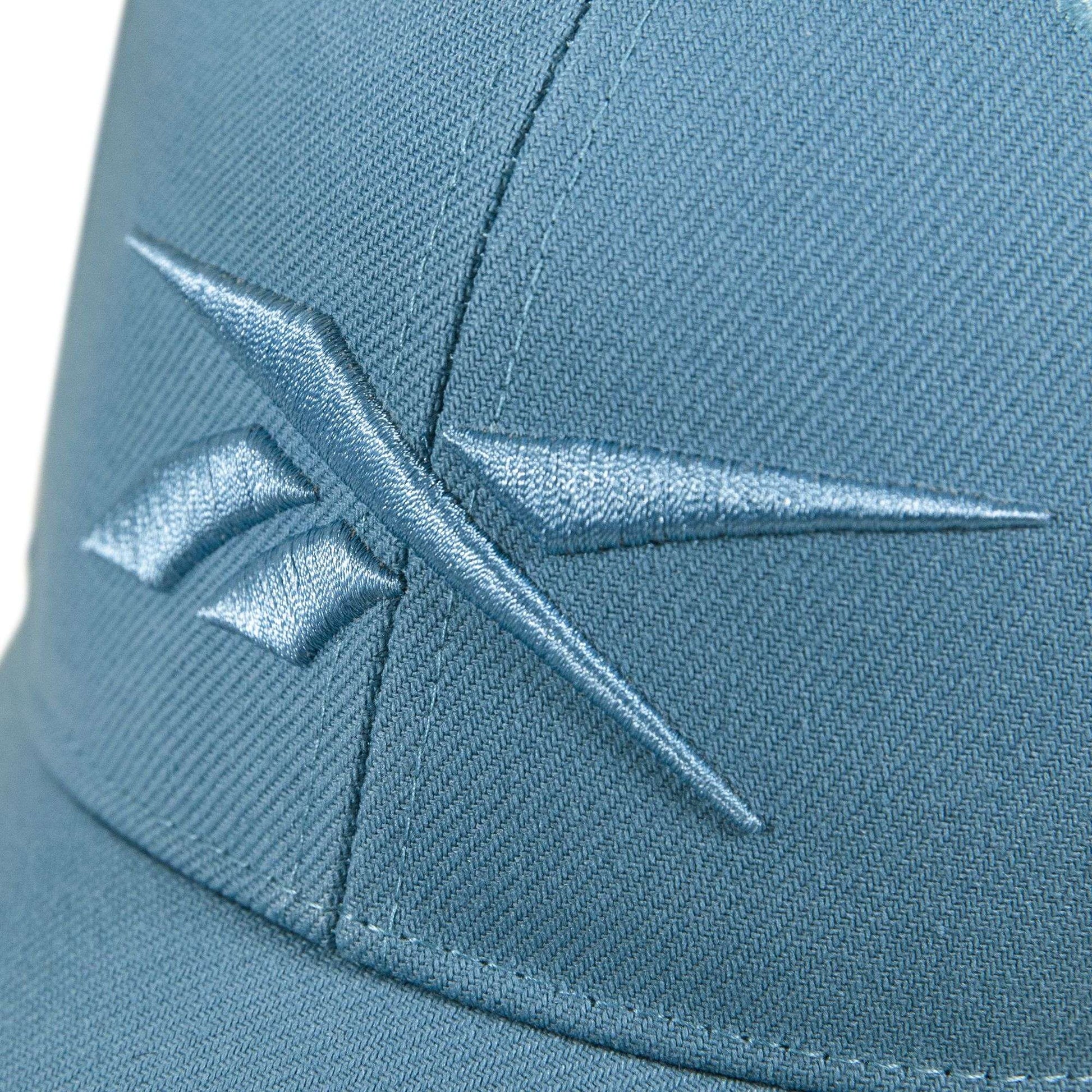 Close-up of the Reebok Vector Baseball Cap in blue, featuring a matching embroidered logo on the front and an adjustable snapback closure for a personalized fit.