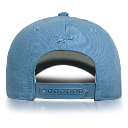 The image displays the back of a blue Reebok Vector Baseball Cap featuring an adjustable snapback closure and the Reebok logo above the opening, blending classic style with sustainable performance.