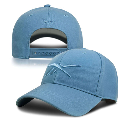 A light blue Reebok Vector Baseball Cap is shown from front and back, featuring an embroidered Reebok logo on the front and an adjustable snapback closure on the back for a custom fit.