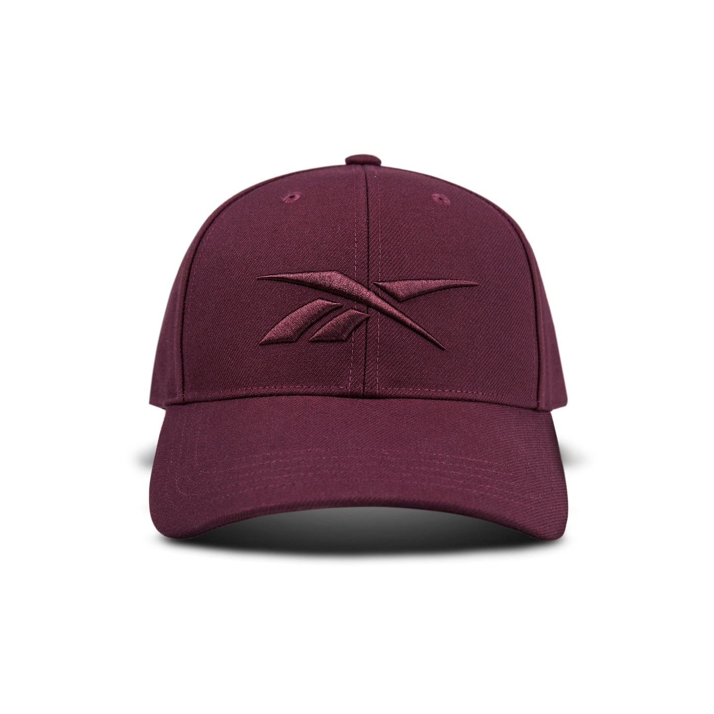 The Vector Baseball Cap by Reebok is maroon with a matching embroidered logo on the front, displayed against a white background.