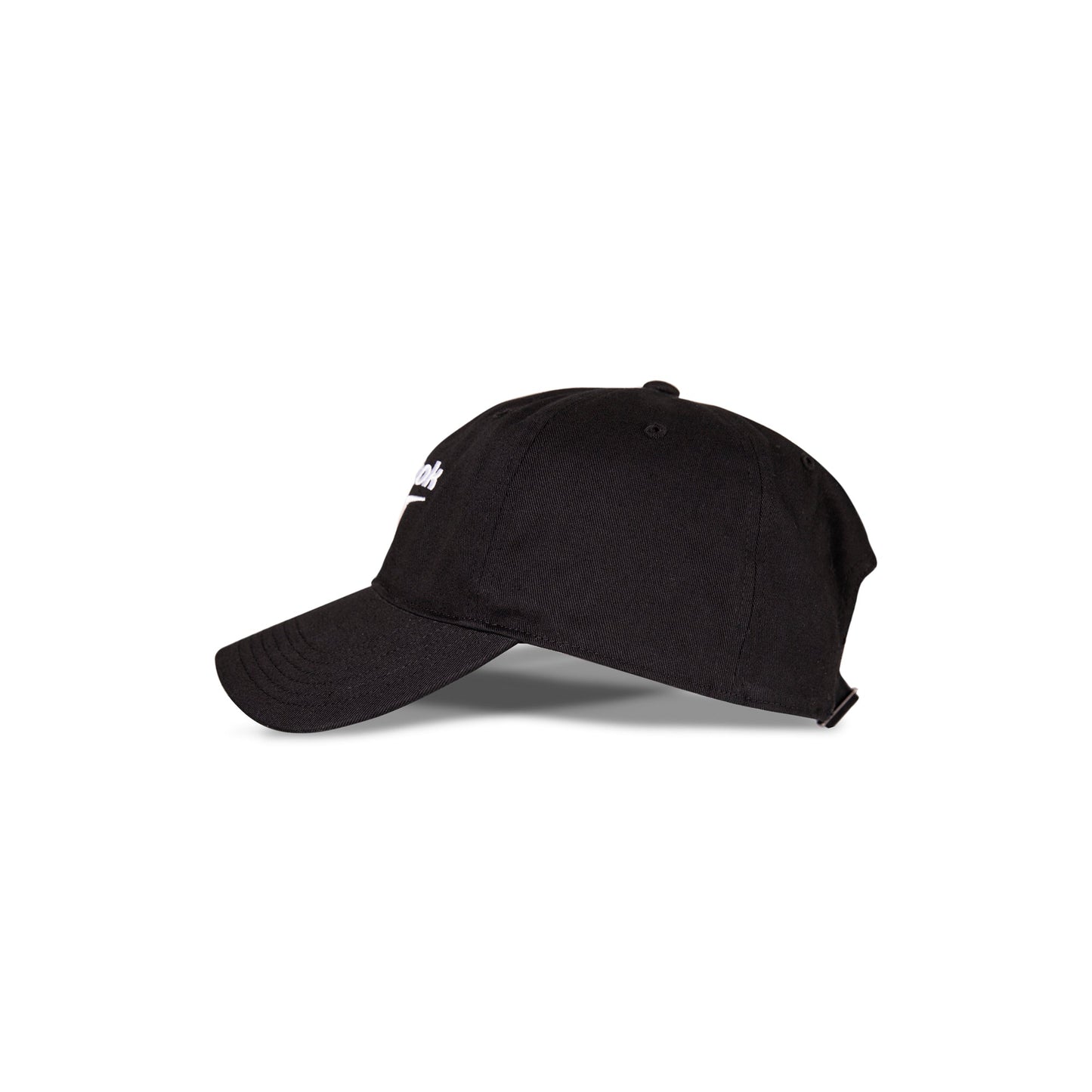 A side view of the Reebok Logo Cap in black cotton twill with a curved brim, adjustable buckle closure, and a partially visible Reebok logo on the front, placed against a white background.