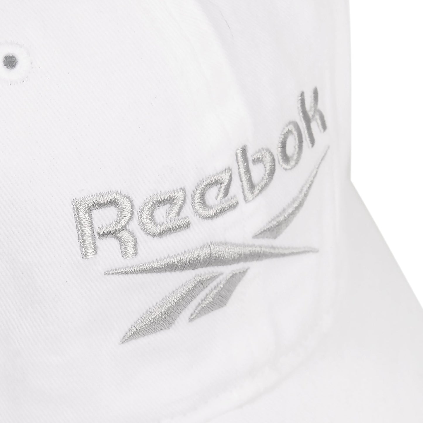 Close-up of the Reebok Logo Cap, crafted from cotton twill with silver embroidered text on the front and an adjustable buckle closure for a perfect fit.
