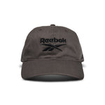 A dark gray Reebok Logo Cap with a black embroidered logo and text on the front is displayed from the front against a white background.