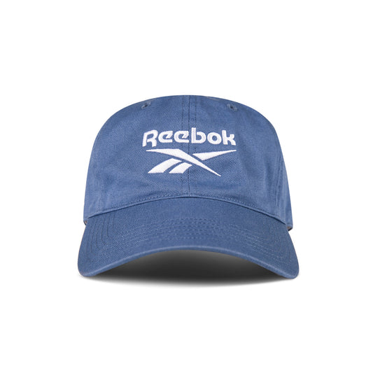 The Reebok Logo Cap features a curved brim and front white logo embroidery. Made from cotton twill with an adjustable buckle for comfort, this cap is shown against a white background.