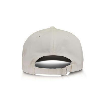 A back view of the Reebok Badge Cap, a plain white baseball cap featuring an adjustable strap and metal clasp, shown on a white background.