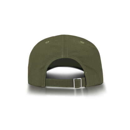 The Reebok Badge Cap in olive green is shown from the back, highlighting its adjustable strap with metal buckle and stitched top eyelets. The cap sits on a white background with a subtle shadow underneath.