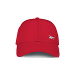 The Reebok Badge Cap in bright red is shown from the front, featuring a small white embroidered logo on the lower right crown and an adjustable buckle for comfort.