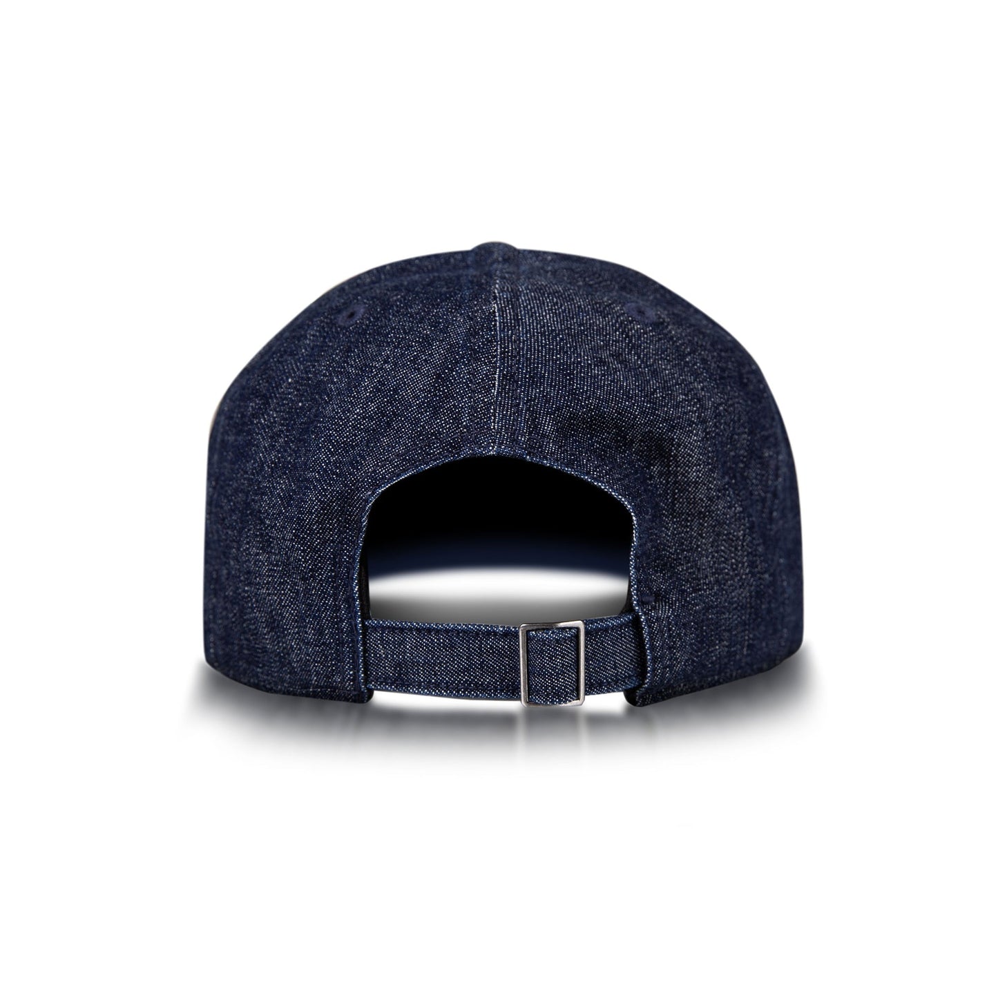 The Reebok Denim Badge Cap is shown from the back with an adjustable strap, metal buckle, and Speedwick sweatband. This dark blue cap appears on a white background with a subtle shadow beneath it.