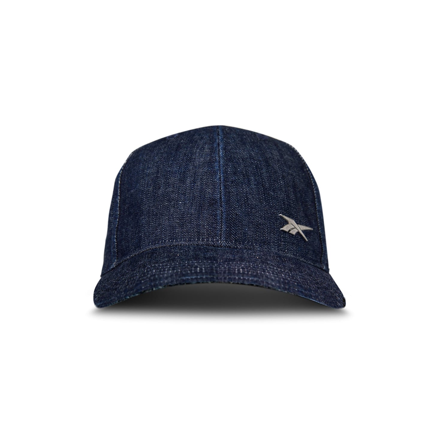 The Reebok Denim Badge Cap is a dark blue premium denim hat featuring visible stitching, a small silver logo on the lower right front, and a Speedwick sweatband, shown against a white background.