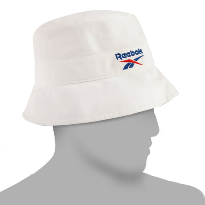 The Reebok Bucket Hat, made from recycled nylon with the signature blue and red logo, adds streetwear style on a mannequin's head against a minimalist backdrop.