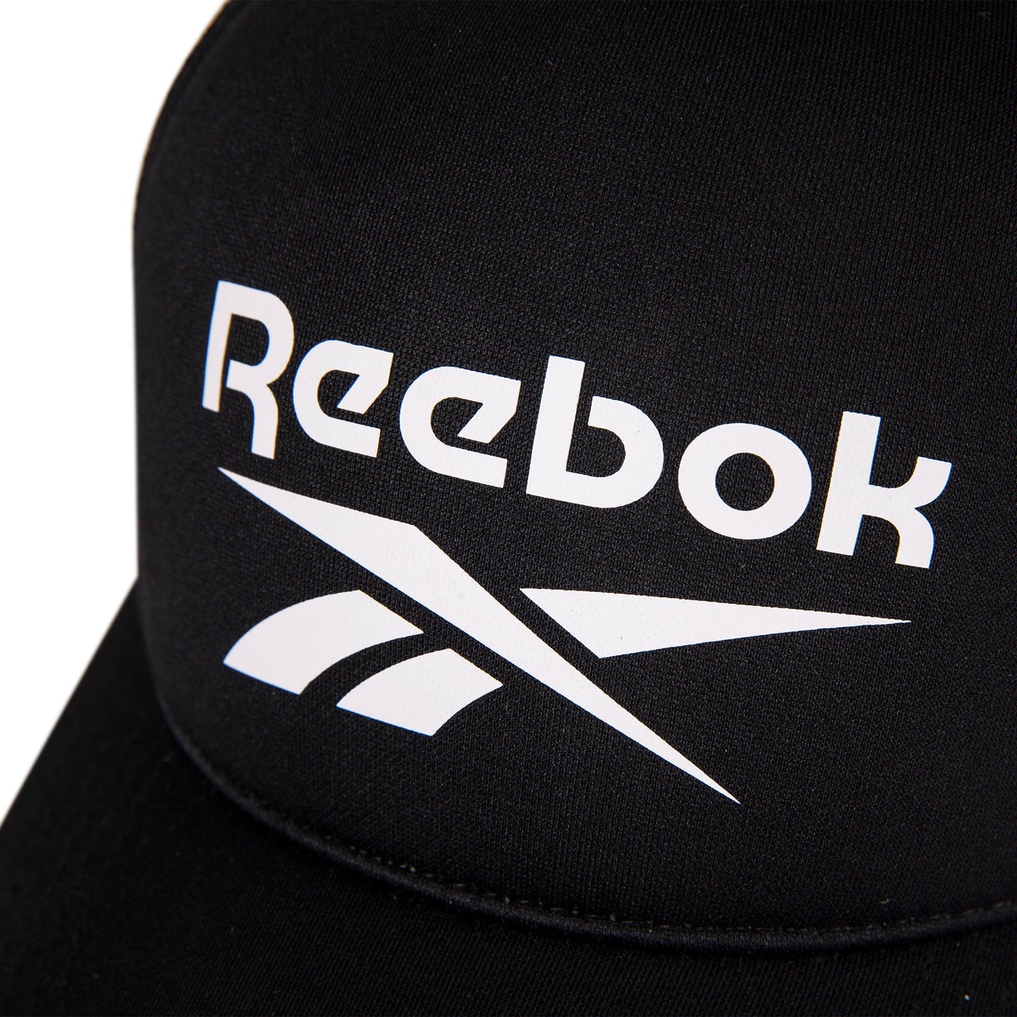 Close-up of the Reebok Aero Cap, a black athletic hat featuring a white Reebok logo and text on the front, crafted from moisture-wicking fabric for comfort.