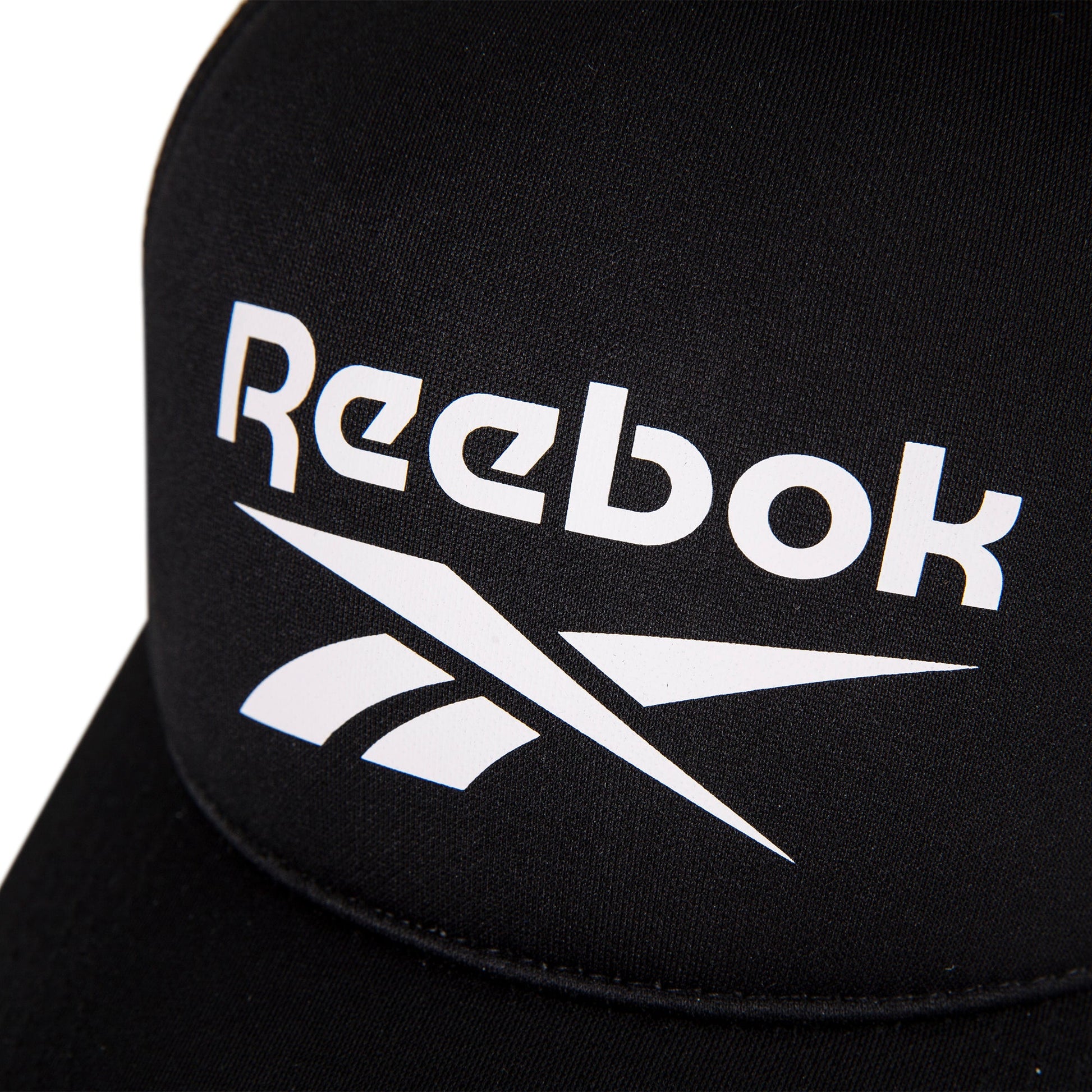 Close-up of the Reebok Aero Cap, a black athletic hat featuring a white Reebok logo and text on the front, crafted from moisture-wicking fabric for comfort.