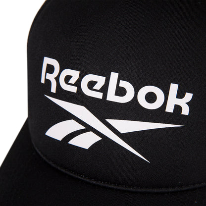 Close-up of the Reebok Aero Cap, a black athletic hat featuring a white Reebok logo and text on the front, crafted from moisture-wicking fabric for comfort.
