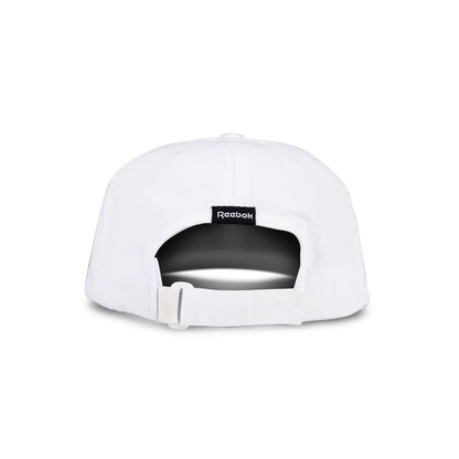 The Reebok Flow Cap in white is shown from the back, with an adjustable fabric strap and buckle, a black Reebok logo tag above the opening, and a moisture-wicking sweatband for comfort.